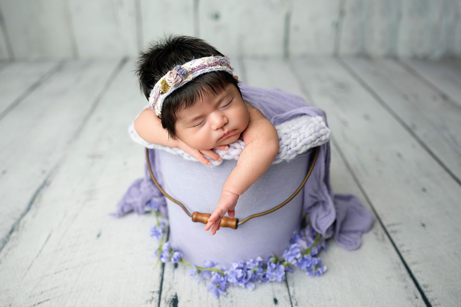 Newborn baby posed on a soft blanket in the studio