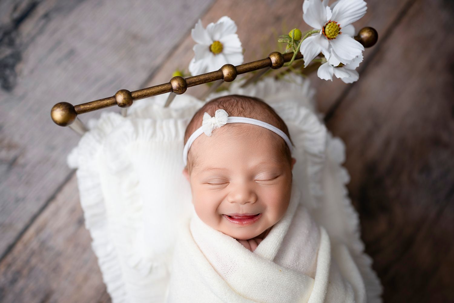 Newborn baby photographed with a soft headband